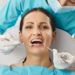 A dentist in Indian Trail, NC, examines a woman patient's oral care during a clinic visit.