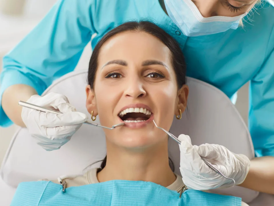 A dentist in Indian Trail, NC, examines a woman patient's oral care during a clinic visit.