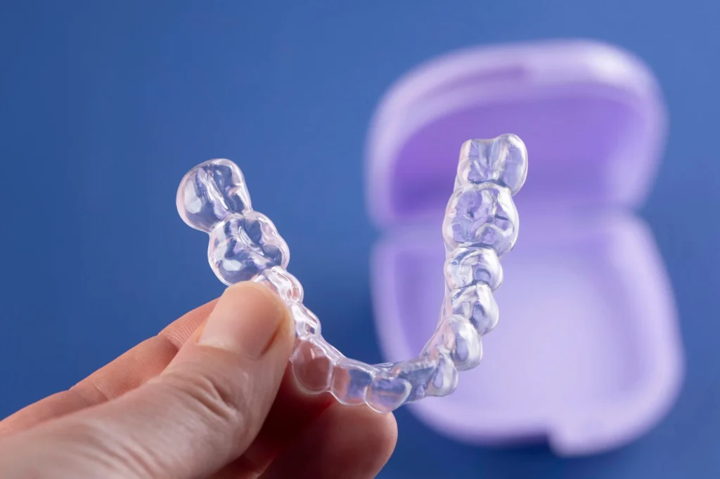 Invisalign-in-Matthews-NC-with-blue-backgroud-and-purple-case