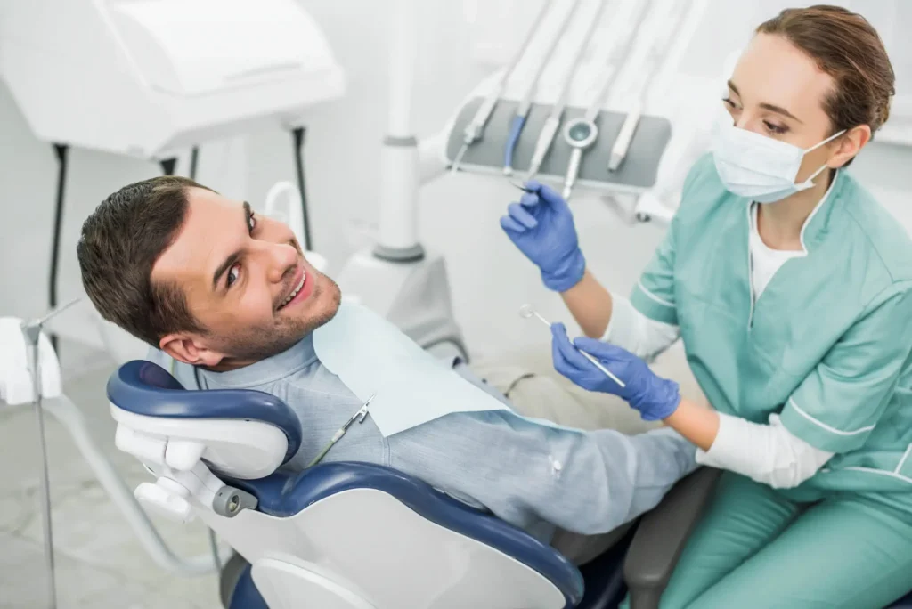 Dentist-Near-Matthews-NC-Holding-Dental-Instruments-During-Exam