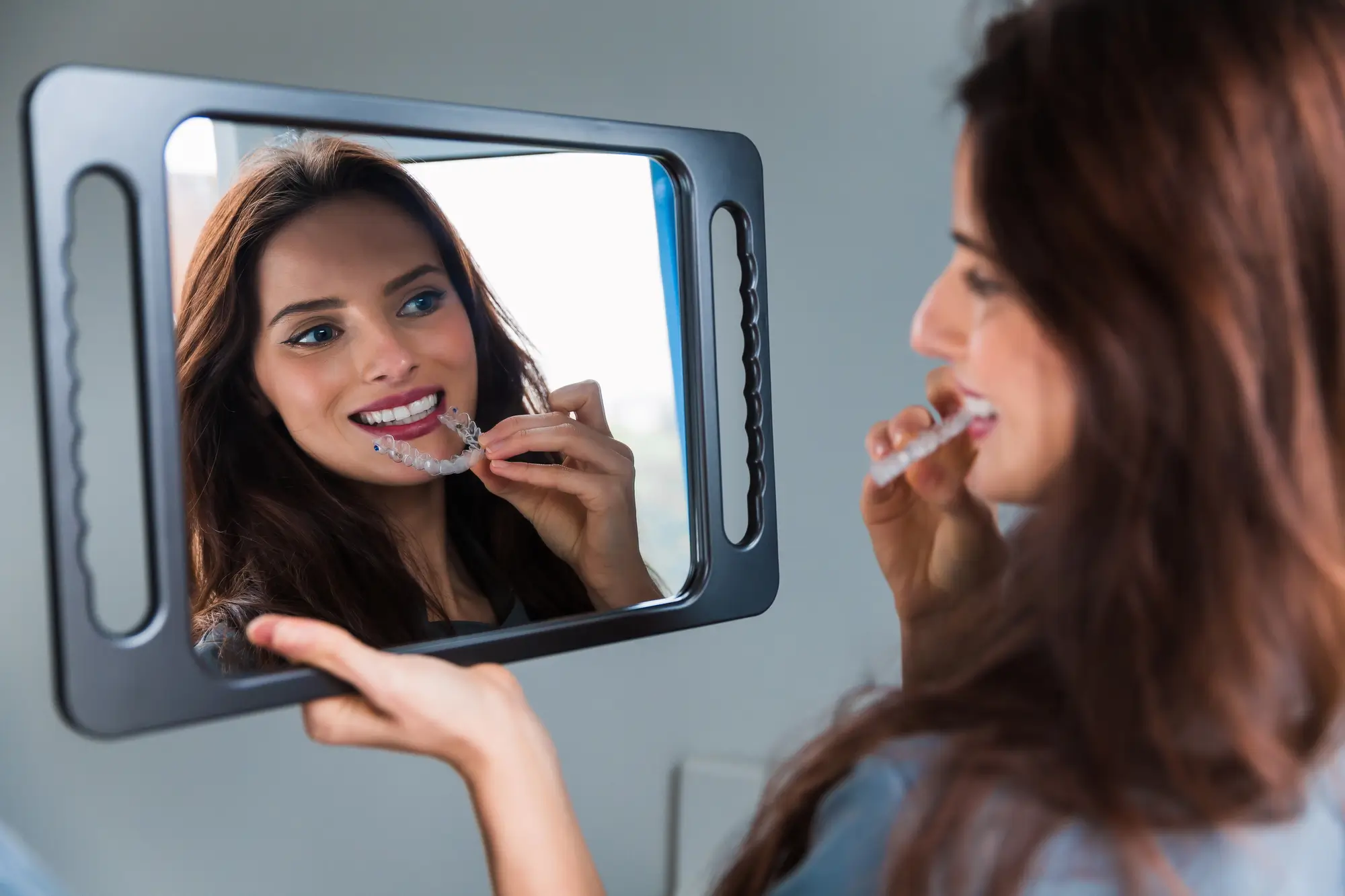 Young Woman Wearing Invisalign Dentist Matthews NC Aligners
