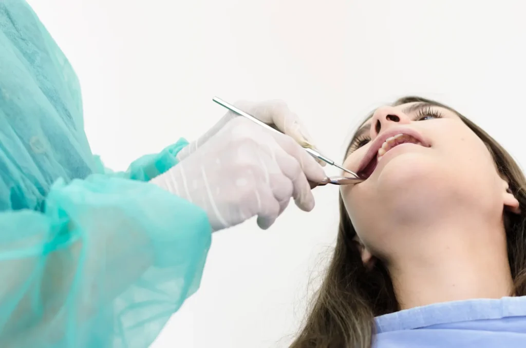 Dentist performing tooth removal procedure, emergency dentist Matthews NC