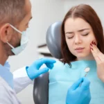 Young woman with toothache visiting emergency dentist Matthews NC