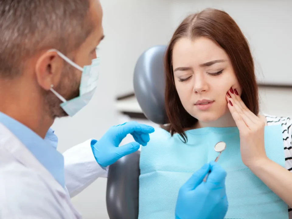 Young woman with toothache visiting emergency dentist Matthews NC